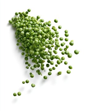Fresh green peas scattered on a white surface, showcasing vibrant color and texture.