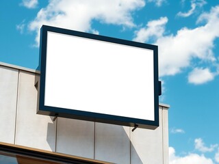 Fototapeta premium A large digital screen mounted on the side of a building under a blue sky