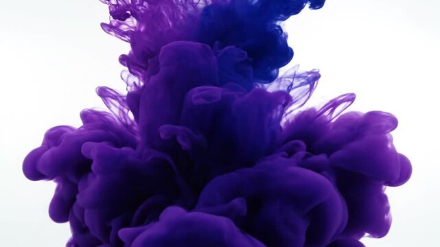 Blue ink drop cloud diffusing in clear white water.