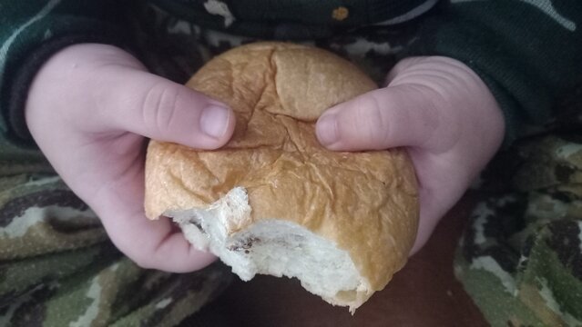 Kids hand holding bread