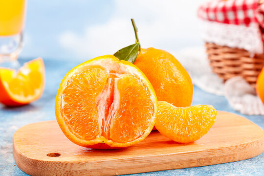 Fresh Cut Mandarin Oranges with Juicy Citrus Pulp on Wooden Board
