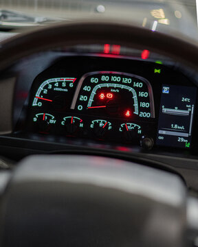 Close Up View of Car Dashboard and Steering Wheel In Motion.