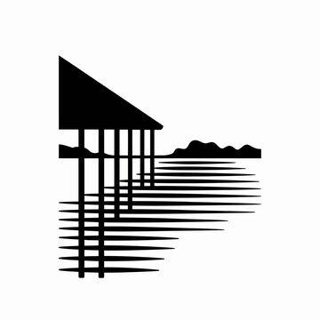 A black silhouette of a wooden pier over the calm water