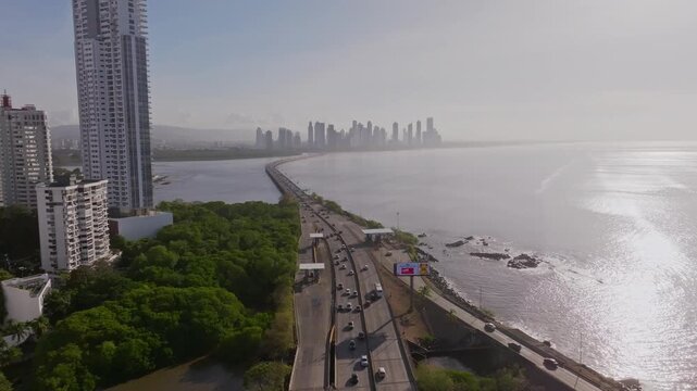 South corridor in Panama City during sunrise with Costa del Este in the background, wide shot with drone flying backwards