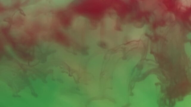 Wave paint. Liquid texture. Defocused green red crimson color acrylic water flowing smog floating on abstract art creative background.