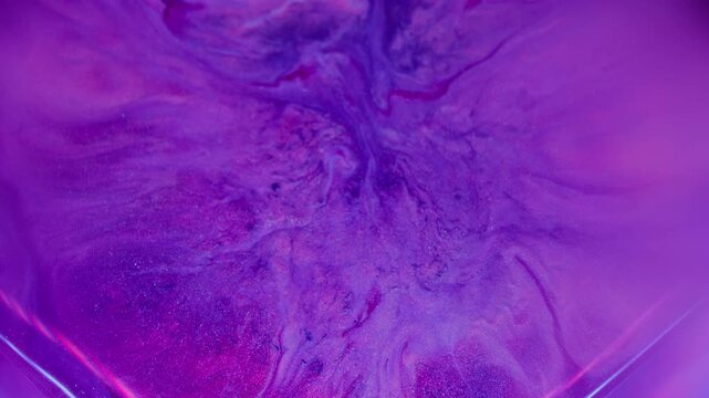 Blur paint spill. Neon ink flowing. Defocused purple pink blue color cube splash chemical texture spilling on abstract acrylic background.