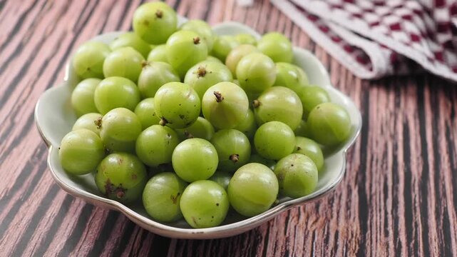 Fresh amla on a wooden table for healthy eating