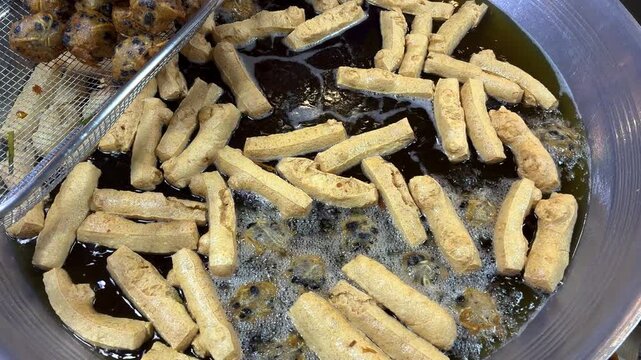 Static Close-Up of Deep Frying Tofu and Taro Balls at Thai Street Food