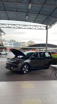 Seremban, Malaysia - February 28, 2026: Outdoor exhibition view of a grey Proton e.MAS electric car with its hood and doors open at Aeon Seremban 2.