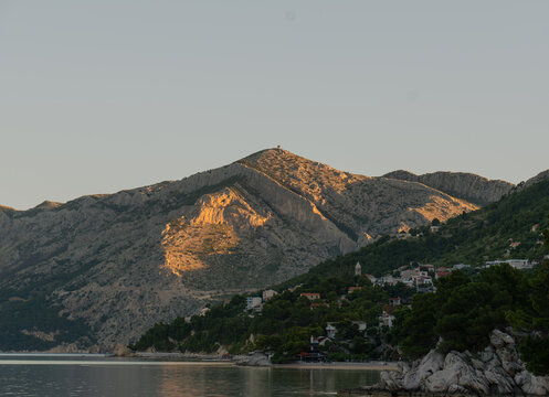 Scenic sunset view of Biokovo mountain and sea coast in Brela, Makarska Riviera