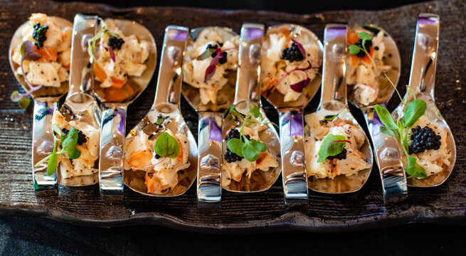 Canapes on spoons with seafood and caviar