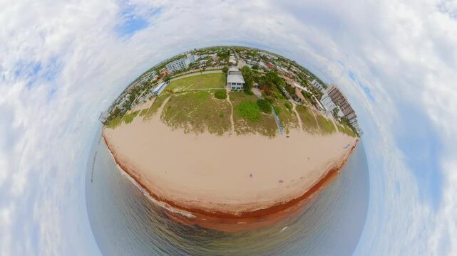 Tiny planet aerial video sargassum seaweed on the shore Fort Lauderdale Florida