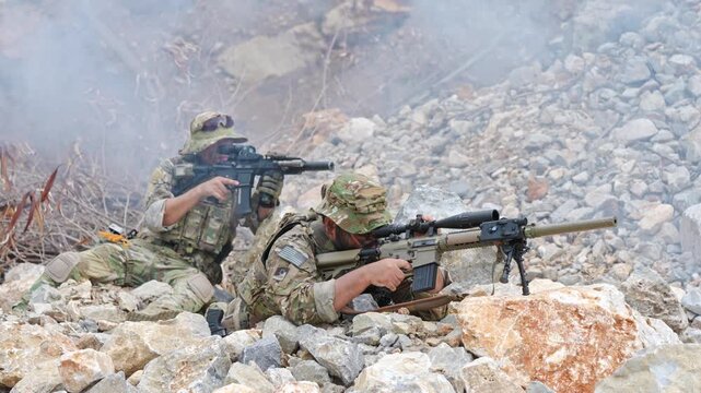 Military snipers in action combat zone high-intensity training rocky terrain ground level tactical precision
