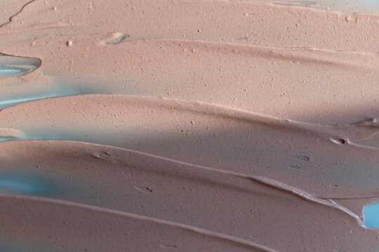 Beige liquid foundation smear, concealer texture smudge. Make up base drops, cream textured background. Closeup macro. Cosmetic tonal makeup moisturizer, bb cream swatch