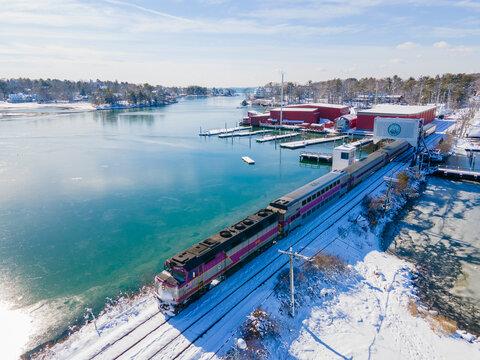 MBTA Commuter Rail General Motors EMD F40PH locomotive on the bridge at Manchester Harbor in historic town center of Manchester-by-the-Sea, Massachusetts MA, USA. 