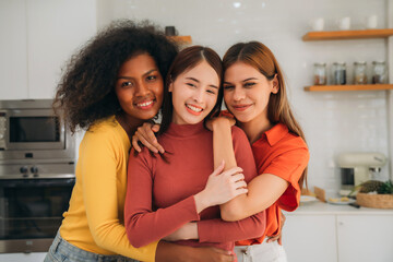 Obraz premium Happy Smiling Diverse Young Women Friends Hugging Together While Enjoying Cooking Healthy Food in Bright Modern Home Kitchen.