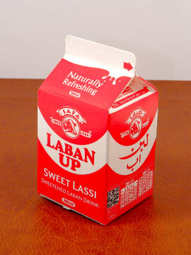 sweet lassi drink labeled safa Laban Up, prominently displaying its refreshing qualities and branding in bold red and white colors against a plain background.
