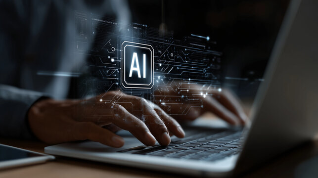 Person typing on laptop with ai interface on screen in dark room