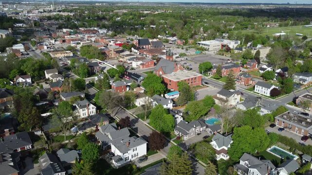 Aerial view of Milton, Ontario, Canada as shot from a drone on a mixed sunshine and clouds spring day in May, 2022. Hovering and then moving forward towards Main Street.