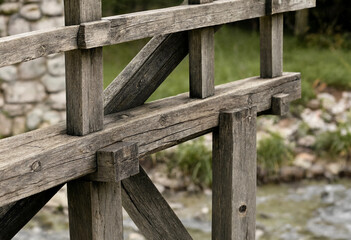 Naklejka premium Detailed view of a rustic wooden bridge structure showing heavy timber beams, notched joints, and sturdy construction over a flowing stream