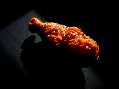 Shadow-drenched succulence, a single chicken wing succumbs to a ravenous embrace, texture ablaze,  dark,  chiaroscuro