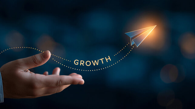 Concept of Growth and Ambition: A hand holds out a glowing paper airplane embarking on a journey, symbolizing growth, progress, and aspirations against a dark, starry backdrop.