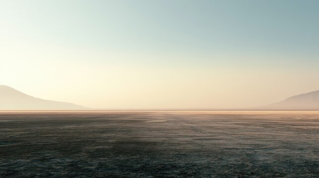 Hazy horizon over barren land with distant, soft-edged mountains