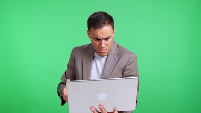 Stressed businessman working on laptop gets angry