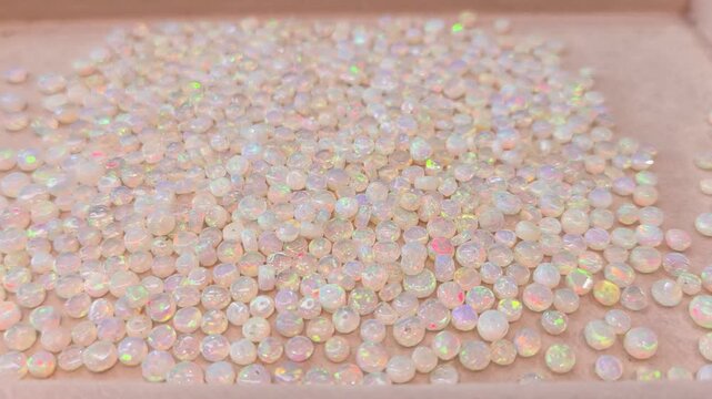 White opal loose stone on tray and Tweezers