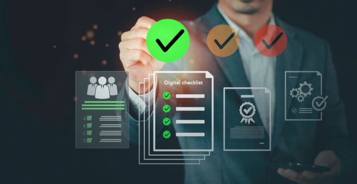 Businessman holding green check mark on digital checklist interface. Concept of online data management, document control, target audience selection, and corporate business strategy.