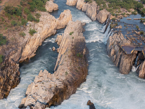 Drone close-up of Dhuandhar Waterfall and marble rock canyon on the Narmada River in Bhedaghat, Jabalpur, India.