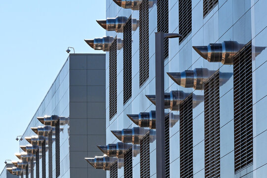 Exterior cooling system exhaust vents on a large data center building, representing thermal management, digital infrastructure, and cloud computing operations