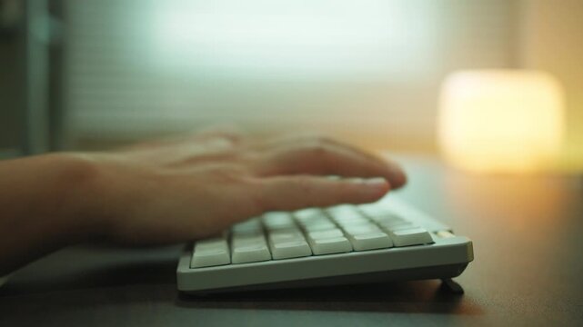Close-up of Hands Typing on White Keyboard, Software Developer and Programmer Working at Wooden Desk. Working space work from home idea concept.