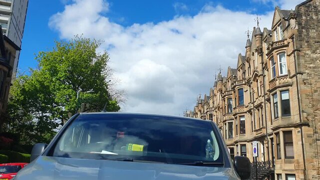 Glasgow Downtown and City Centre Street Tour During Mostly Cold Sunny Day Over Scotland, United Kingdom. City with Historical and Modern Buildings and Street View Was Captured During Street Car Drive