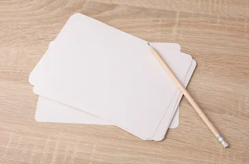 White blank cardboard cards and a pencil on the table. Mockup for design © splitov27