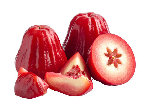 A rustic pile of fresh red water apples or rose fruits jambu air showing bell shapes and crisp sliced pieces on white