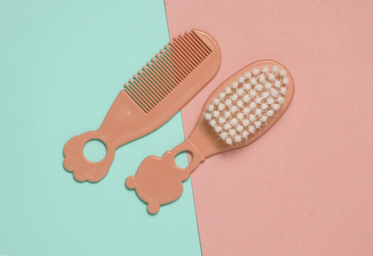Combs and hairbrush for newborn on a blue-pink background