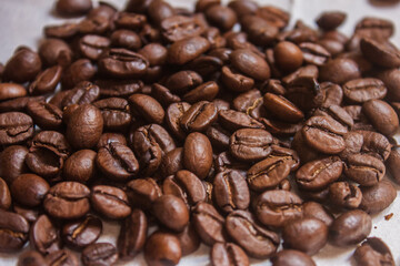 Fototapeta premium Coffee beans artistic shot, brown bean, arabica and robusta, café, caffeine, white background, freshness, shot is selective focus with shallow depth of field, taken at Cairo Egypt