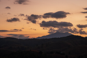 Fototapeta premium Blue golden sky sunrise dramatic beautiful landscape mountain. Dramatic sunset over mountain landscape. Beautiful landscape foggy hills twilight time. Dawn sky gold dusk time cloudscape with sunlight