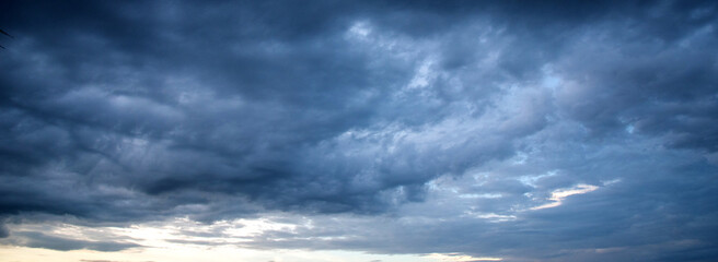Fototapeta premium Banner Dark cloudscape storm disaster gloomy gray cloud sky. Dark thunderstorm clouds rainny atmosphere. Dark cloudscape storm cloud with copy space. Meteorology danger windstorm disasters