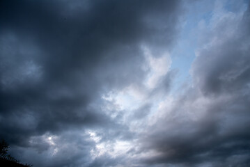 Fototapeta premium Dark cloudscape storm disaster gloomy gray cloud sky. Dramatic dark storm rain clouds black sky background. Meteorology danger windstorm disasters climate. Dark thunderstorm clouds rainny atmosphere