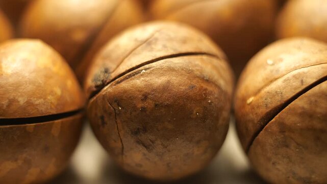 50p macro slider shot moving across premium macadamia nuts texture