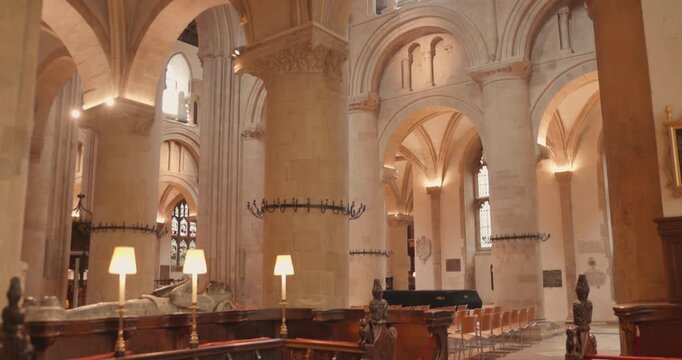 Warm light fills stone arches and columns inside historic cathedral nave in Oxford