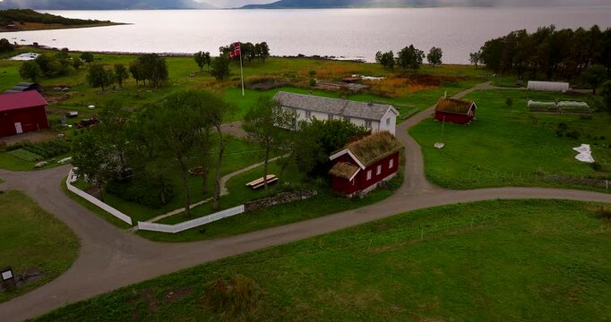 Aerial view of the historic Kvitnes Gaard farm and restaurant located by the fjord in Sortland, Vesteralen, Northern Norway