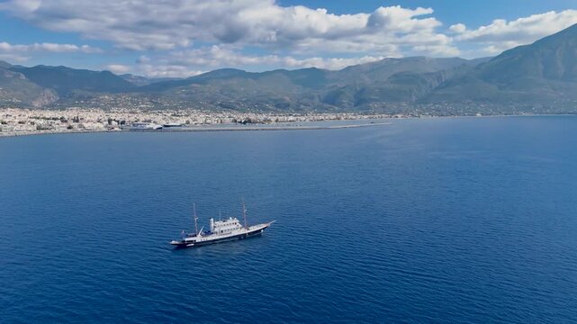 Classic Yacht Cruising Near Kalamata Coastline with Blue Mediterranean Sea and Taygetus Mountains, Aerial View of Messinian Gulf Greece