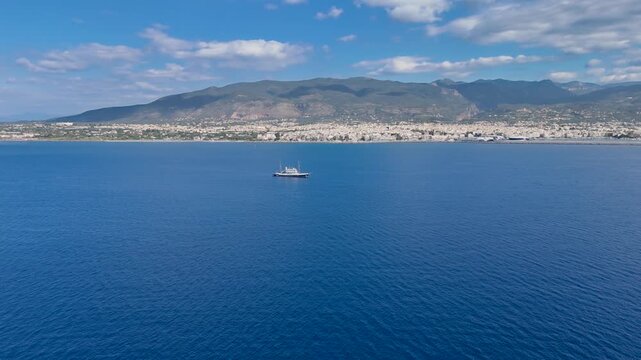 Aerial View of Historic Yacht Near Kalamata Coastline with City Skyline and Taygetus Mountains, Messinian Gulf, Peloponnese Greece