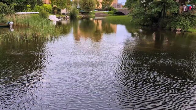 Majestic Galway Cathedral reflected in peaceful Corrib riverside landscape showcasing historic Irish architecture, serene nature, vibrant tourism and cultural heritage beauty