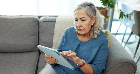 Tablet, relax and senior woman on sofa in home with reading blog on pension funds, savings or...