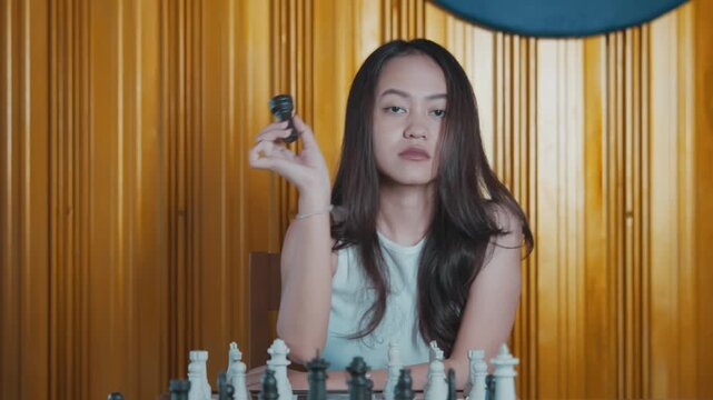 Serious Woman Showing Black Chess Piece to Camera