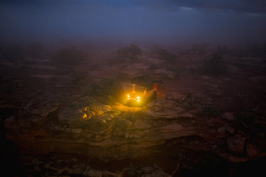 Off road vehicle camping in a foggy desert wilderness at night